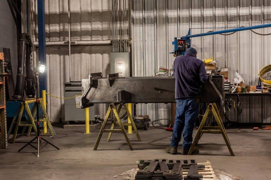 Fabricator working on Elliott outrigger housing assembly
