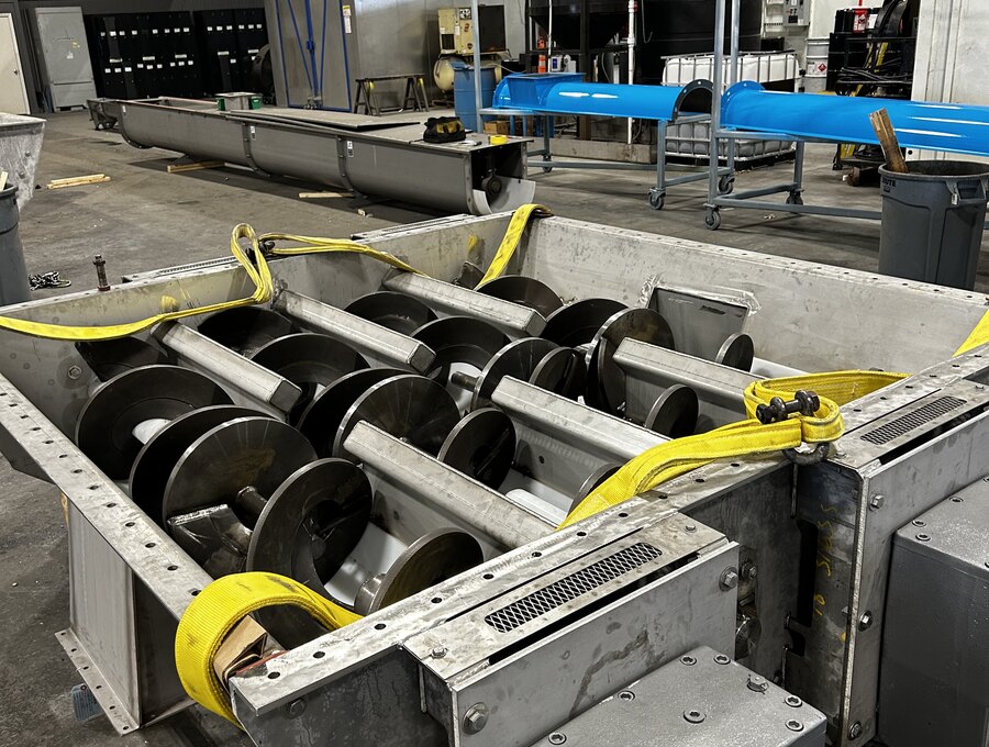 Stainless steel quad screw feeder with drive package, built by Orthman Conveying Systems